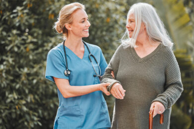 Support care and caregiver walking senior woman